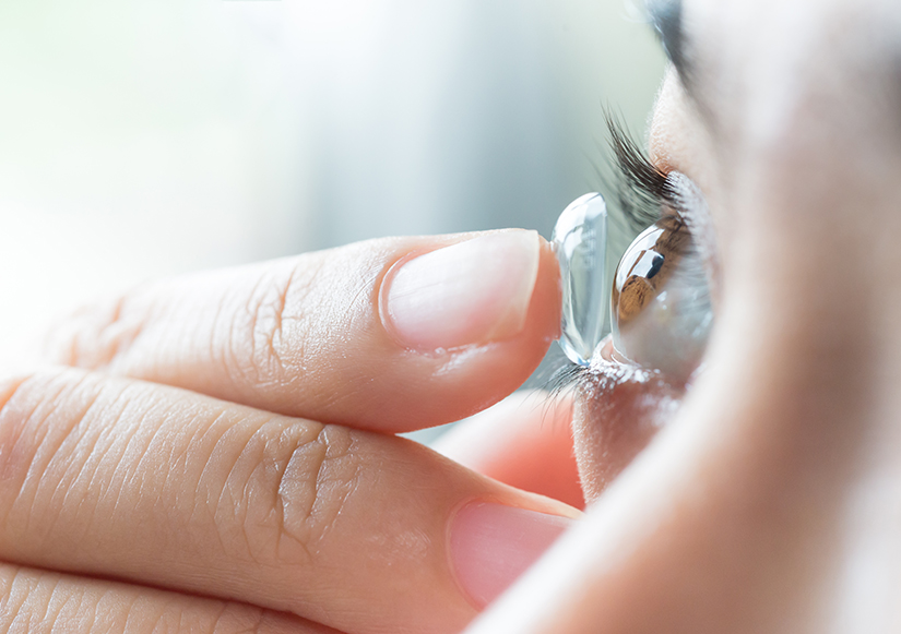 woman putting in contact lenses